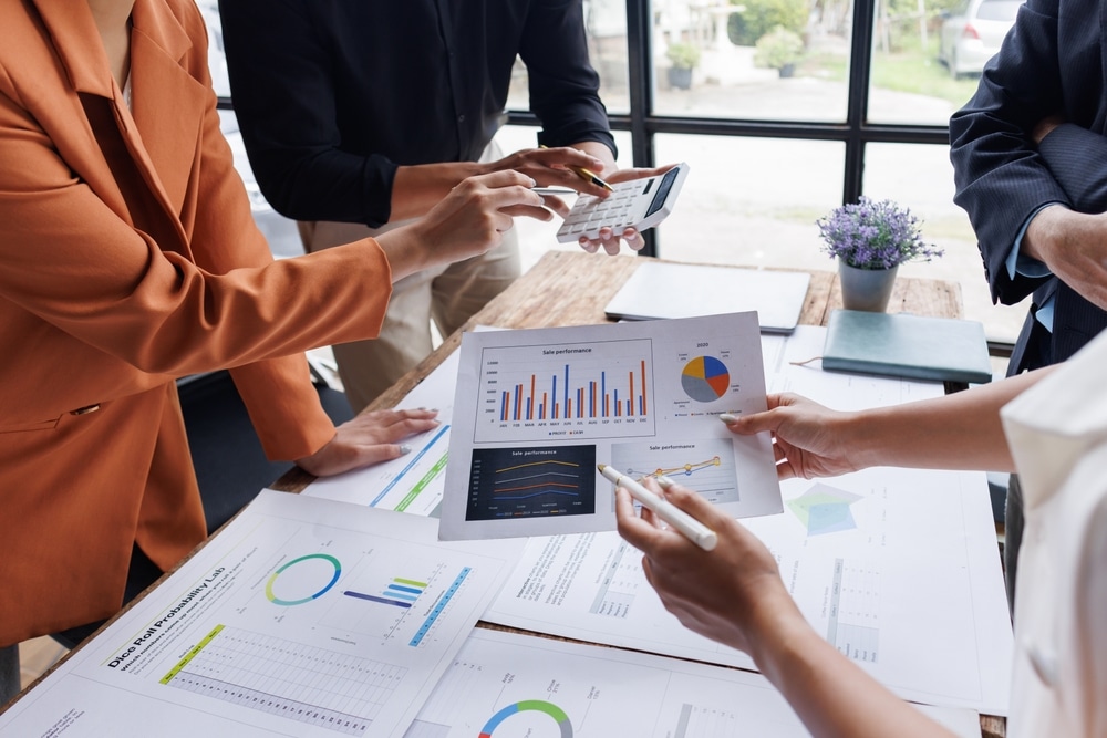 Analyze,Financial,Data,And,Accounting,Record,With,Calculator,In,Meeting A sheet of paper showing a customer profile